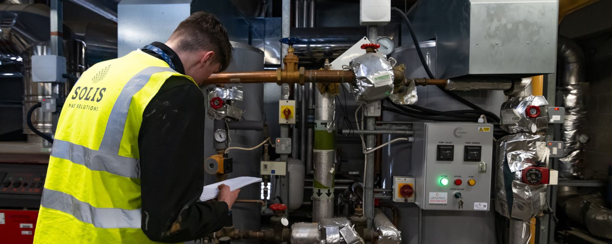 Engineers monitoring an industrial facility from its control room